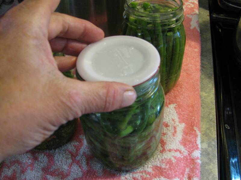 placing the plastic lid on top of the rubber ring.