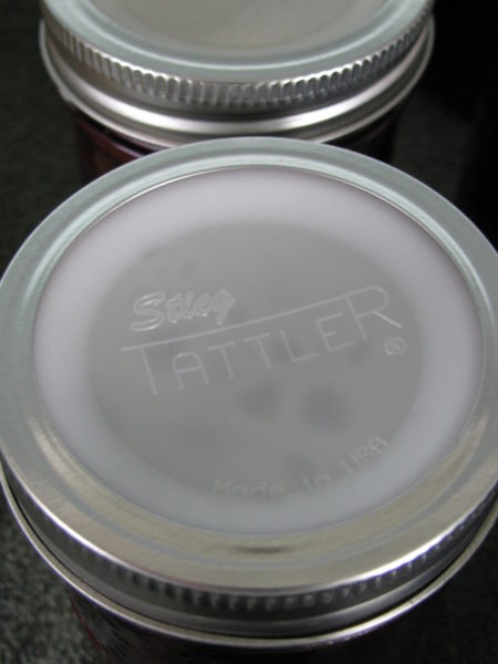 A Tattler lid and seal on a jar of cherries.