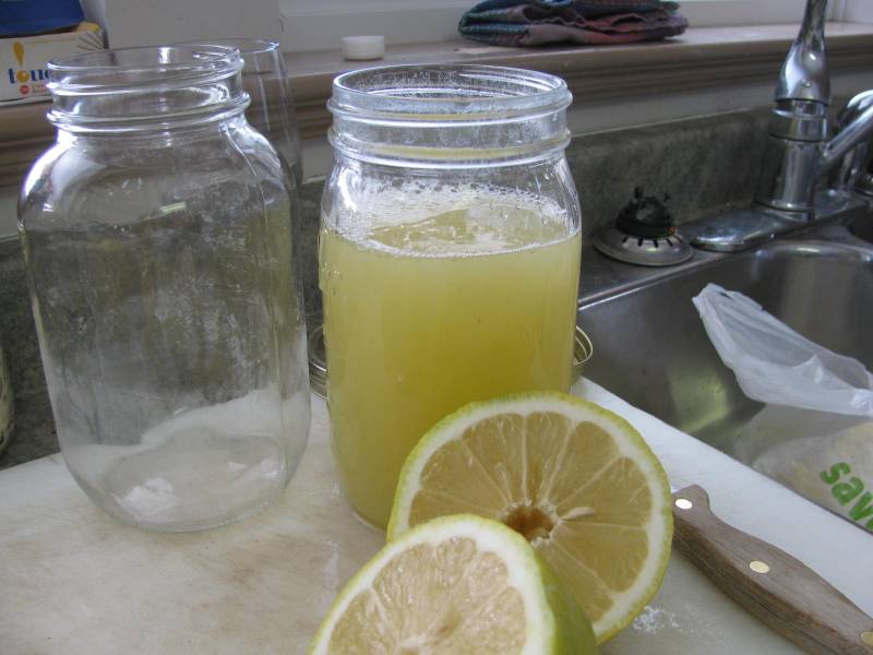 Freshly squeezed lemon juice is poured into a mason jar, leaving lots of headroom.