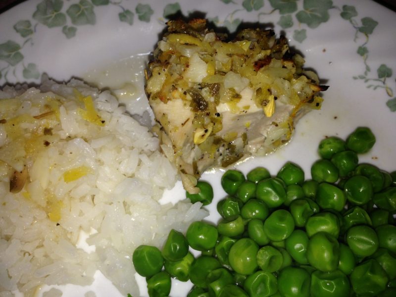 Lemon chicken with rice and peas.