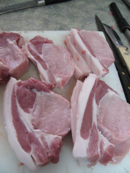 Pork chops on a cutting board