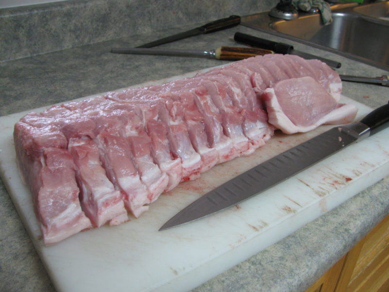 A pork loin after it has been sliced into pork chops.