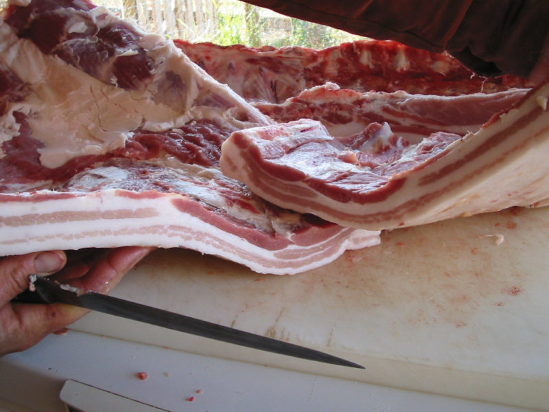 Slabs of unsliced bacon from a butchered pig
