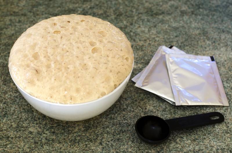 adding yeast to warm water to make pizza dough