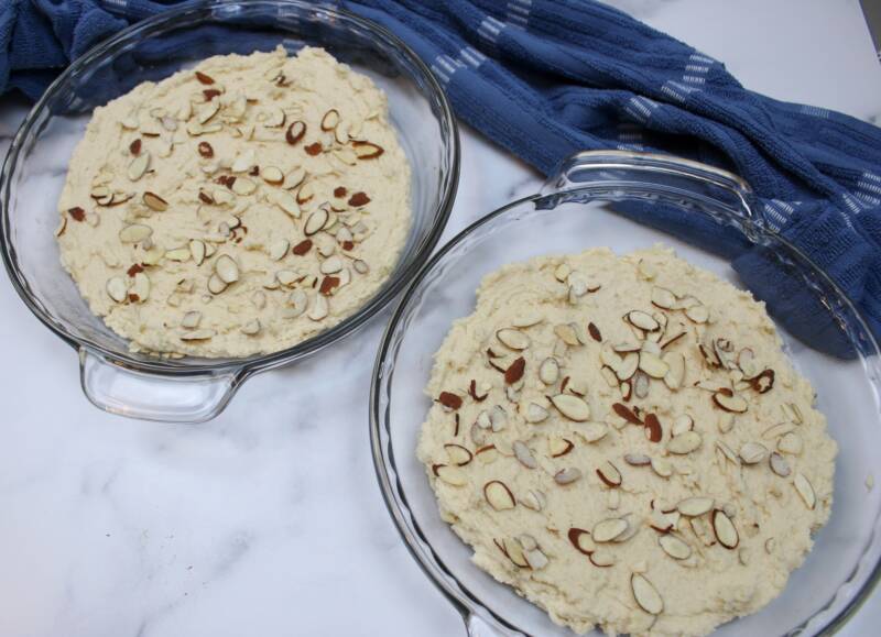 Almond slivers pressed into the top of Boterkoek batter.