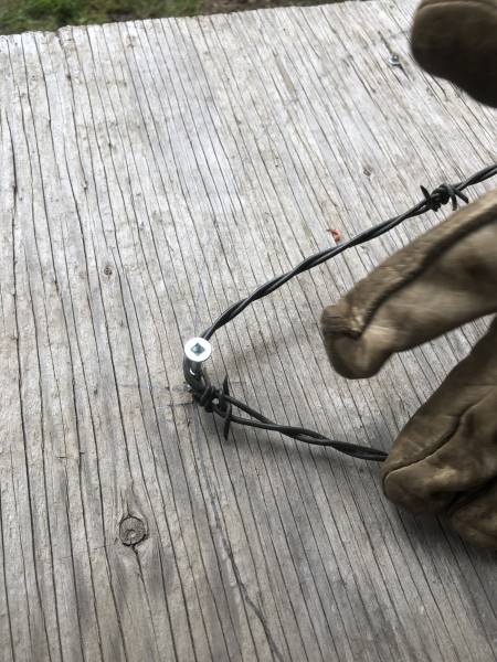 beginning to twist barbed wire to form the base of the star