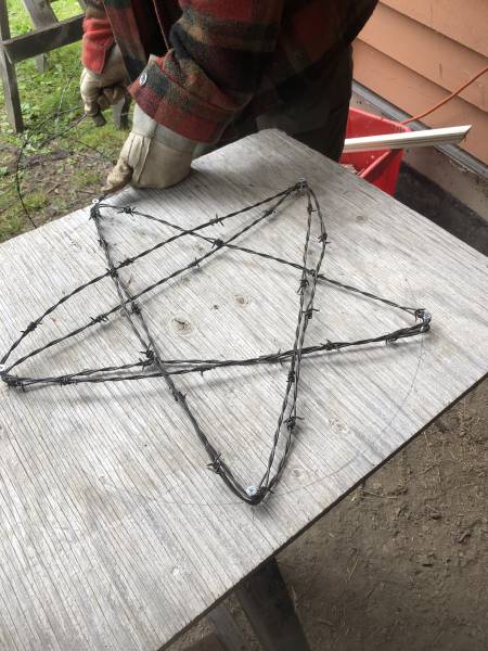 wrapping barbed wire around screws to form a star shape