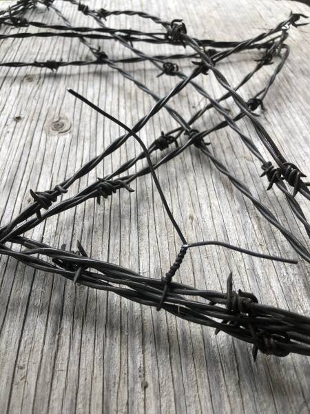 barbed wire wrapped around screws to make a star shape