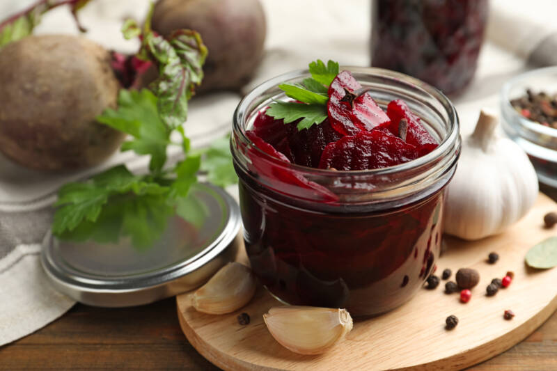 Make and preserve pickled beets like these pretty beet slices in a mason jar.