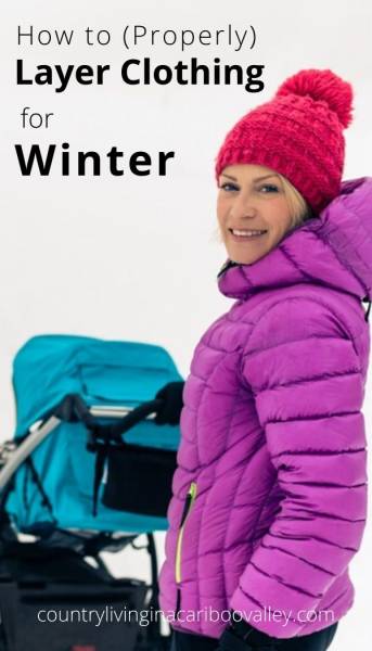 a bundled up women with a stroller in the snow