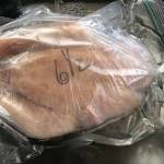 frozen chicken being thawed for cooking