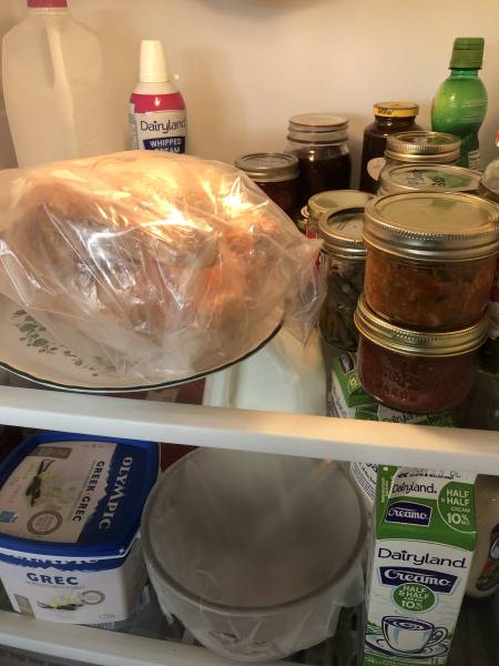 Frozen chicken thawing in the fridge.
