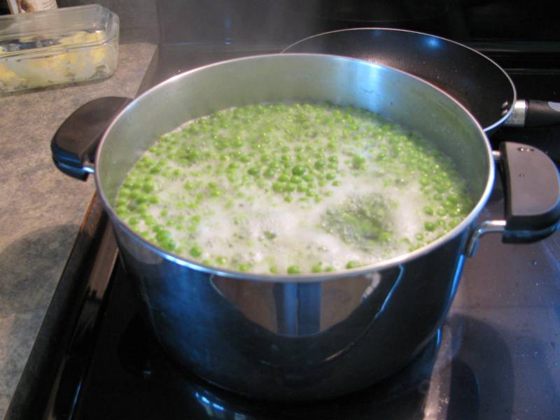boiling peas in a large pot on the stove