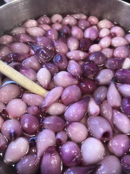 Small onions being heated for pickling.