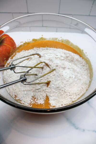 Mixing dry ingredients well with wet ingredients.