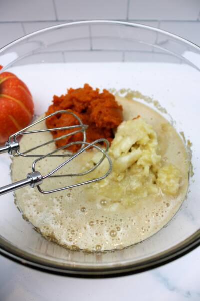 Pumpkin, bananas and other wet ingredients being blended together.