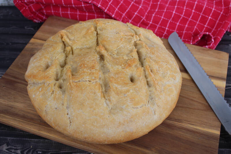 No knead bread warm out of oven on a cutting board.