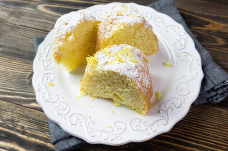 Meyer Lemon Bundt cake sliced on a white plate.