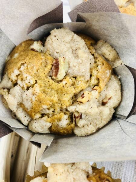 Baked muffin in a muffin liner.