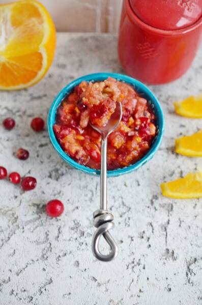 Cranberry orange relish in a bowl with a spoon.