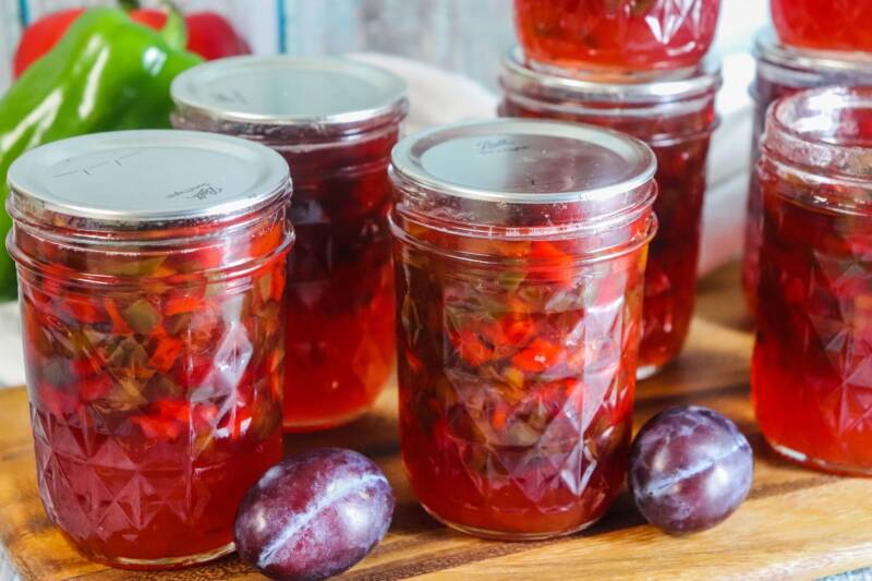 Jalapeno Plum Jelly in jars on counter.