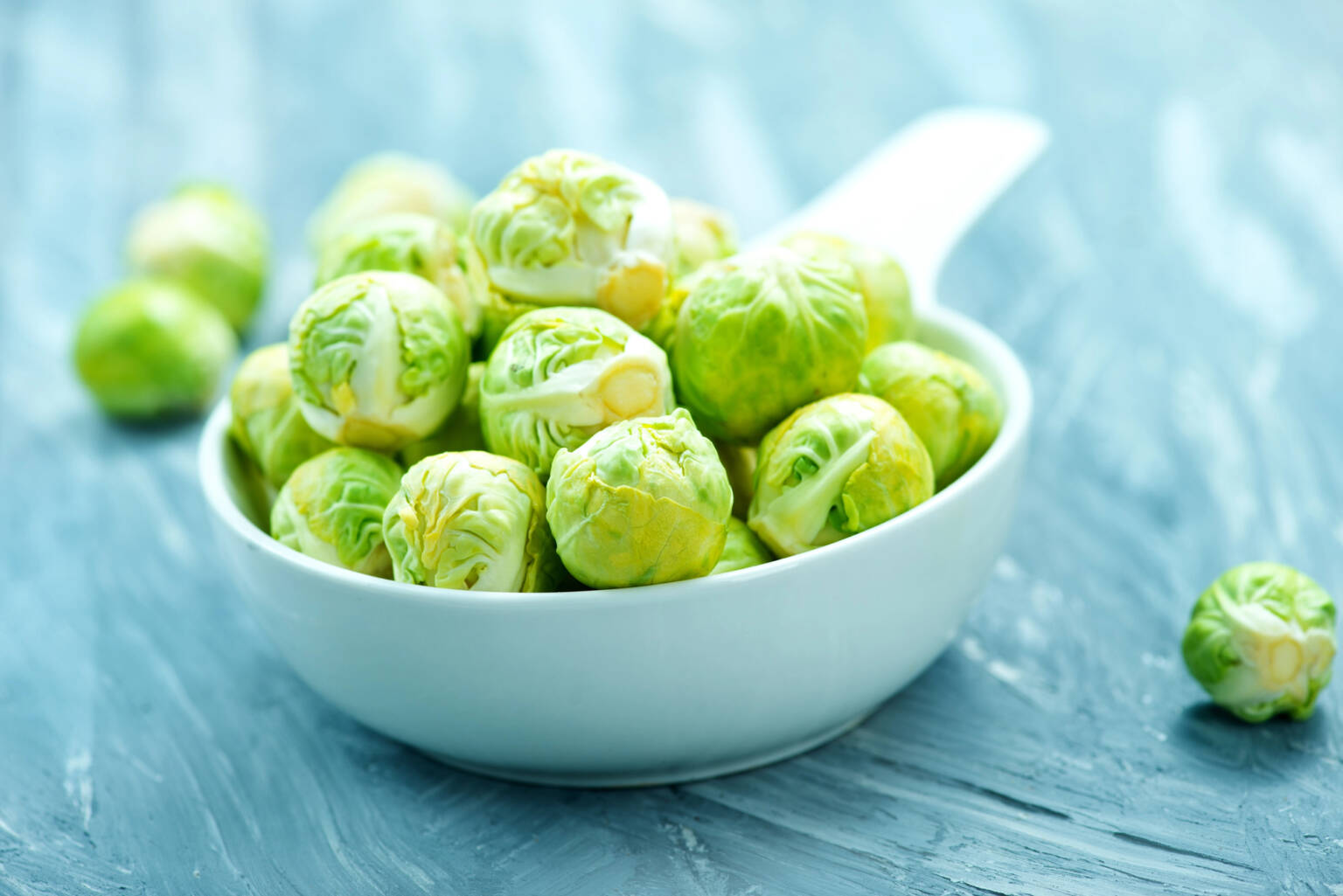 Washed Brussel Sprouts in a white baking dish.